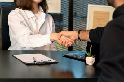 Interviewer shaking hands with hiring manager